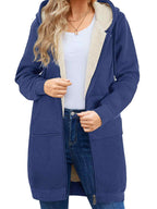 Person wearing a blue hoodie with a white shirt and jeans on a white background