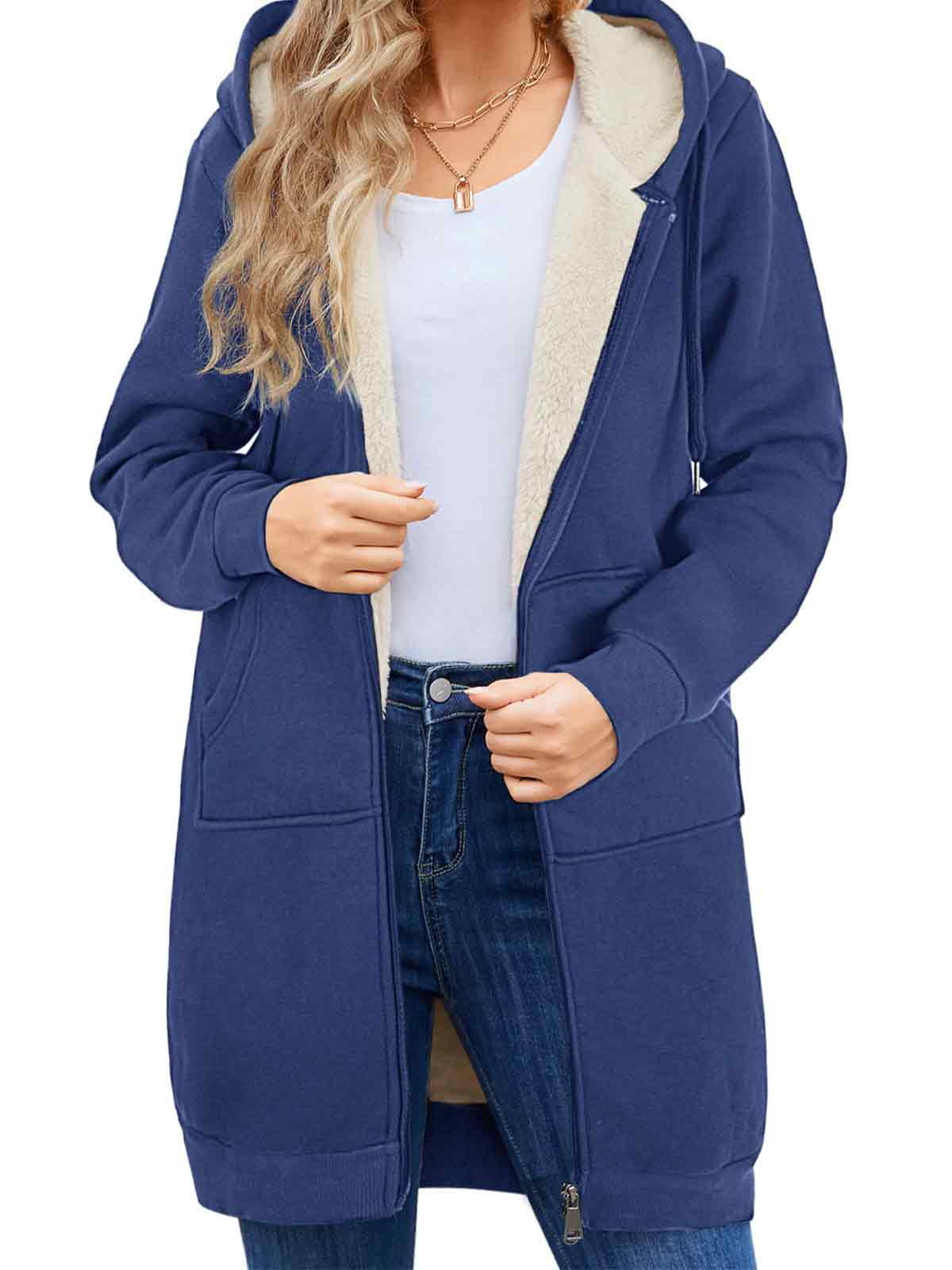 Person wearing a blue hoodie with a white shirt and jeans on a white background
